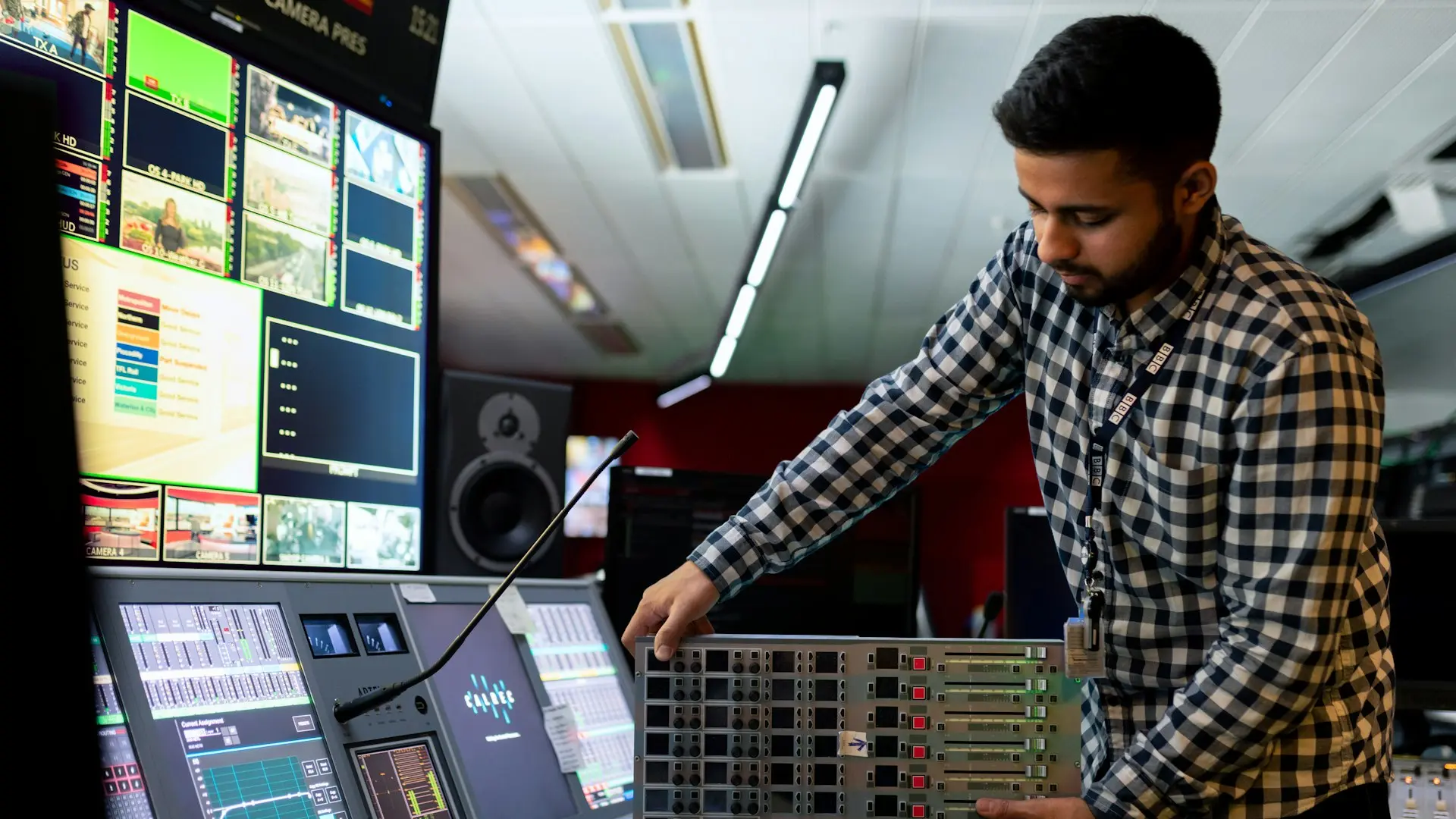 man in black and white checkered dress shirt playing dj controller